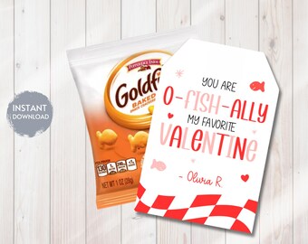 May include: A bag of Pepperidge Farm Goldfish baked snack crackers next to a Valentine's Day gift tag. The tag reads "You are O-FISH-ALLY my favorite Valentine" in red and pink. The bag of crackers is orange and white.