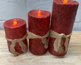 Primitive pillar candles covered in red wax