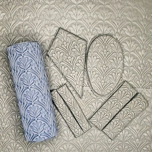 May include: A set of four decorative rubber stamps with a floral pattern. The stamps are in the shape of a rectangle, a circle, and two ovals. The stamps are designed to be used with paint or ink to create a decorative pattern on a surface. The stamps are shown on a background with a similar floral pattern.