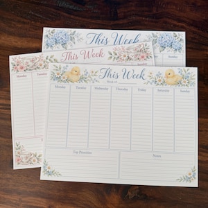 May include: Three weekly planner sheets featuring floral borders and illustrations of yellow ducklings or teacups. Each sheet includes the text This Week, columns for Monday through Sunday, and sections for Top Priorities and Notes with lined spaces.