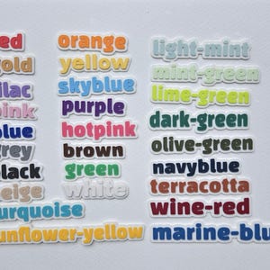 May include: A collection of colorful word stickers, each displaying a different color name. Colors include red, orange, yellow, green, blue, purple, and many more. The stickers have a white border.