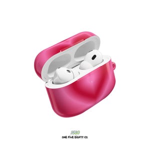 May include: A bright pink, open AirPod case with white interior and white AirPods. The case is glossy and has a smooth texture. The text "1580 ONE FIVE EIGHTY CO." is printed at the bottom.