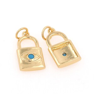 May include: Two gold lock charms, one with a blue evil eye design and the other plain.
