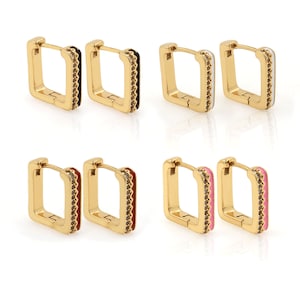 May include: Four pairs of gold square hoop earrings with different colored enamel accents. The earrings have a black, white, pink, and red enamel accent.