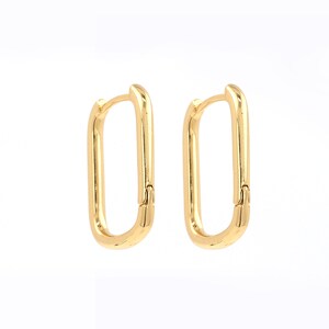 May include: A pair of gold-toned hoop earrings with a rectangular shape. The earrings have a hinged closure.