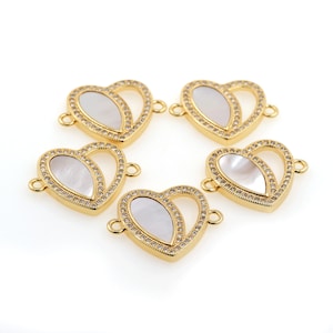 May include: Five gold heart-shaped connectors with a white mother-of-pearl inlay and clear crystal accents.