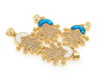 May include: Gold-toned pendant charms in the shape of stylized children. The charms are encrusted with clear crystals and feature either a blue or white opal-like head. Each charm has a loop for attaching to a chain.