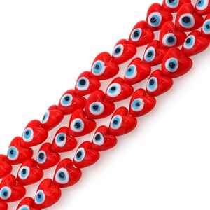 May include: A strand of red heart-shaped beads with blue evil eye charms. The beads are strung on a clear thread.