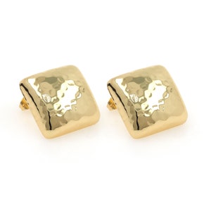 May include: A pair of gold square-shaped earrings with a hammered texture.