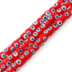 May include: A strand of red glass beads with blue and white evil eye designs. The beads are round and have a glossy finish.