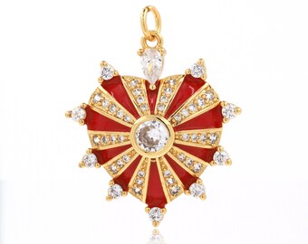 May include: Gold heart-shaped pendant with red enamel and clear cubic zirconia stones. The pendant has a sunburst design with a large central stone.