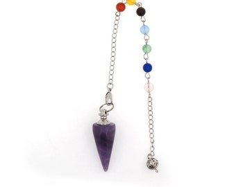 May include: A purple amethyst crystal pendulum with a silver chain and a silver bead at the bottom. The chain has seven colored beads in a rainbow pattern.