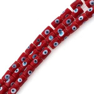 May include: A strand of red glass beads with blue and white evil eye charms.