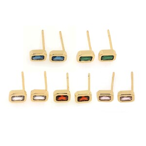 May include: Eight pairs of gold stud earrings with different colored rectangular gemstones. The colors include blue, green, white, red, and pink.