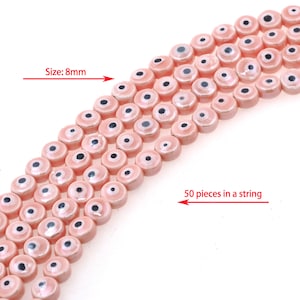 May include: A string of 50 pink and black evil eye beads, each bead is 8mm in size.  Size: 8mm. 50 pieces in a string.