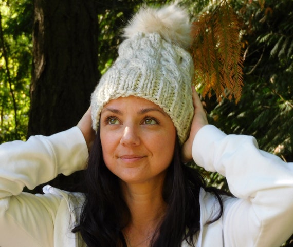 cable knit beanie with faux fur pom