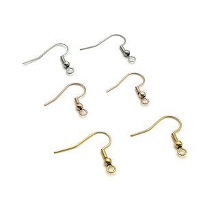 May include: Four pairs of earring hooks with a small ball at the end. Two pairs are silver, one pair is gold, and one pair is rose gold.