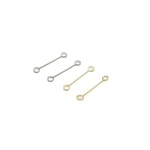 May include: Four metal jewellery connectors. Two are silver-coloured, and two are gold-coloured. Each connector has a straight bar with a loop at each end. The connectors are arranged on a white background.