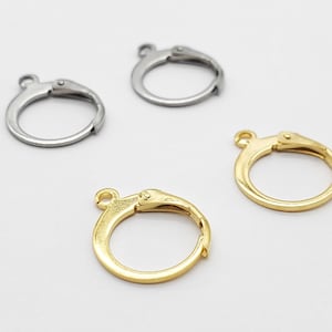 May include: Three earring hooks, two silver and one gold. The hooks are made of metal and have a spring-loaded clasp.