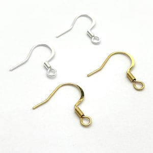 May include: Four earring hooks, two silver and two gold, with a spring closure. The hooks are made of metal and are designed for attaching earrings.