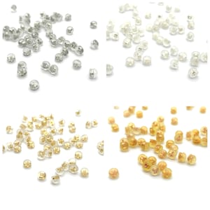 May include: Assortment of clear plastic earring backs in four colours: clear, silver, gold, and amber. The backs are designed to secure earrings to the earlobe.