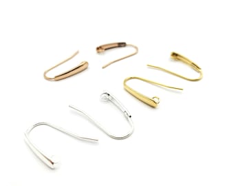 May include: A set of six earring hooks in gold, silver, and rose gold finishes. The hooks are made of metal and have a simple, elegant design.