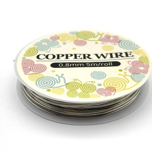 May include: A spool of silver-colored copper wire with a round label featuring colorful snail illustrations. The label text reads COPPER WIRE and 0.8mm 5m/roll. The wire is wound tightly around a clear plastic core, showing a metallic finish.