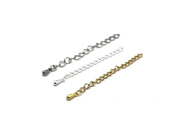 May include: Three metal chain extenders in silver, gold, and gunmetal grey. Each chain has a different style and is designed to add length to necklaces or bracelets. The extenders are displayed against a white background.