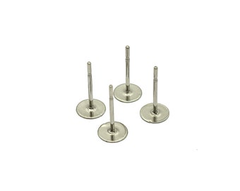 May include: Four silver earring posts with flat backs. The posts are round and have a smooth finish.