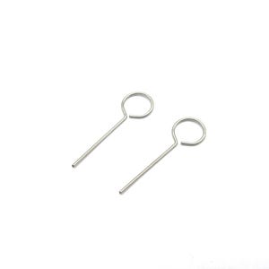 May include: Two silver key ring tools, each with a loop at one end and a straight shaft ending in a point. The tools are set against a white background.