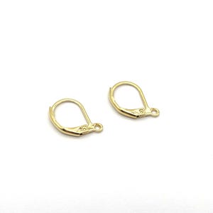 May include: Two gold-coloured earring lever backs on a white background. The earring findings are made of metal and have a curved, hinged design with a small loop at the end for attaching to an earring post. These are jewellery making supplies.