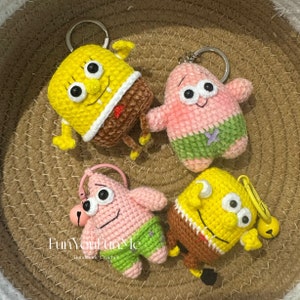 May include: Four crocheted keychains featuring characters from the cartoon Spongebob Squarepants. The keychains are yellow, pink, and brown. The keychains are hanging from a woven basket.