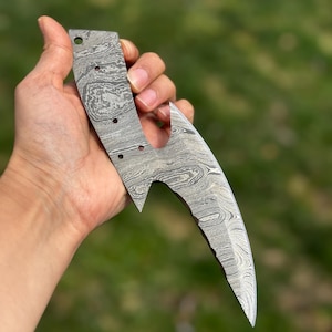 May include: A set of three ceramic mugs with a speckled, matte finish. The mugs are in shades of cream, light gray, and dark gray. Each mug has a simple, modern design and a rounded handle.