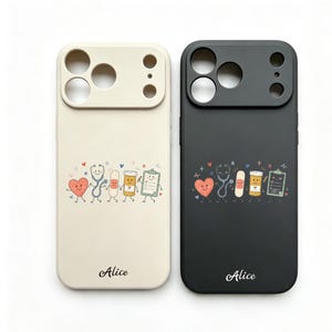 May include: Two phone cases, one cream and one black, featuring a graphic of a smiling heart, stethoscope, bandage, pill bottle, and clipboard. The name Alice is printed in a cursive font at the bottom of each case, which includes camera cutouts.