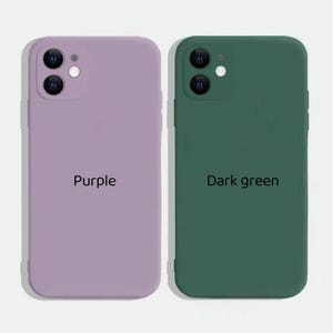 May include: Two silicone phone cases, one purple and one dark green. Both cases have a raised camera bump and the text "Purple" and "Dark green" printed on them.