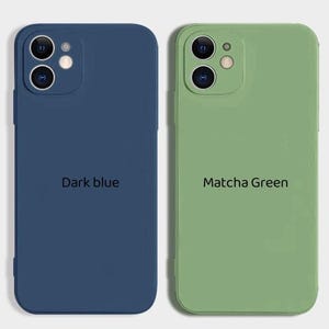May include: Two silicone phone cases, one dark blue and one light green. The dark blue case has the text "Dark blue" printed on it. The light green case has the text "Matcha Green" printed on it.