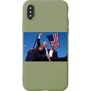 May include: A green phone case with a photo of a man in a suit holding an American flag. The man is surrounded by other people.