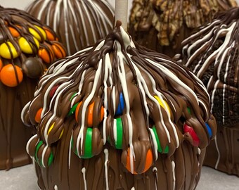 Assorted Carmel Apples Dipped to order with Premium Chocolate! Choose your topping, Oreo, MM, Stroopwafel, Reese's Pieces or Rainbow chips