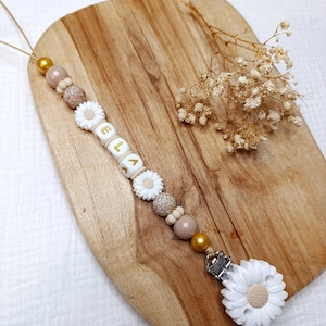 金色の花の文字が入ったシリコン製おしゃぶりクリップ - 女の子用シリコン製おしゃぶりクリップ - パーソナライズされた花のシリコン製おしゃぶりホルダー - クリエーション
