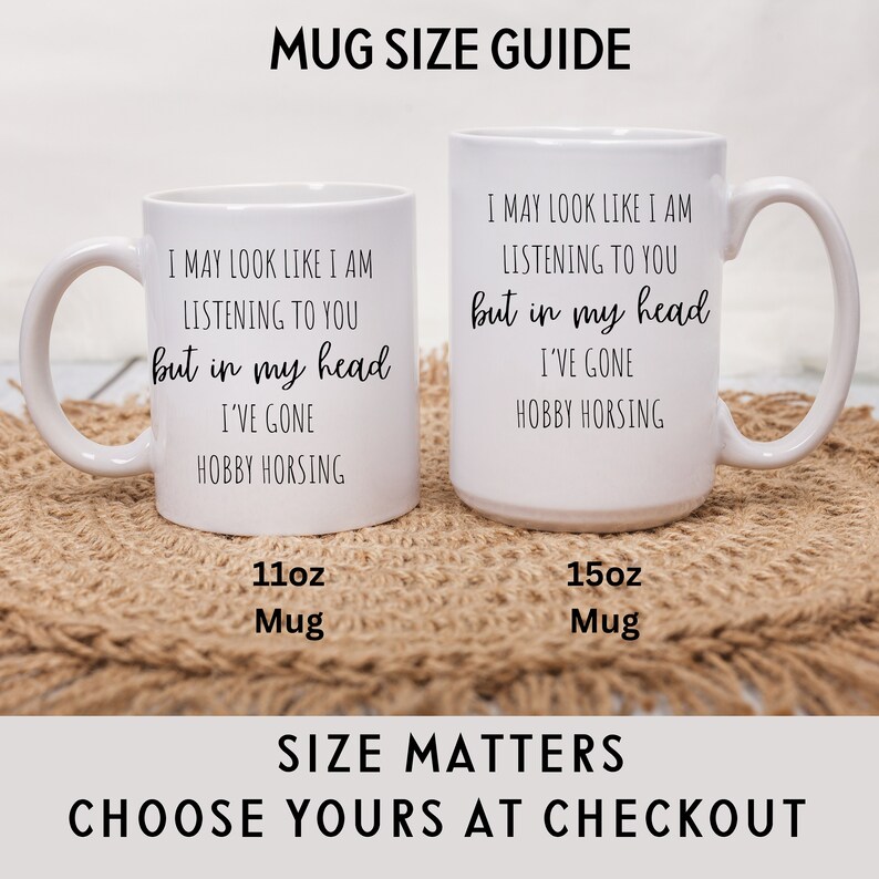 May include: Two white ceramic mugs with black text. The text on both mugs reads "I may look like I am listening to you but in my head I've gone hobby horsing". The mug on the left is labeled "11oz Mug" and the mug on the right is labeled "15oz Mug".