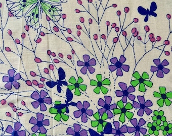 May include: A cream-colored fabric with a floral and butterfly pattern. The design features purple and green flowers, pink berries, and blue butterflies. The butterflies have intricate wing patterns, and the flowers are stylized.