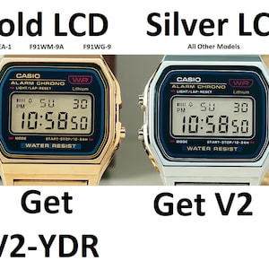 May include: Two Casio digital watches side-by-side. One is gold-toned, the other silver. Both display the time 10:58:50. The gold watch has the text "Gold LCD" above it, and the silver watch has "Silver LCD". The text "Get V2" is below the watches.