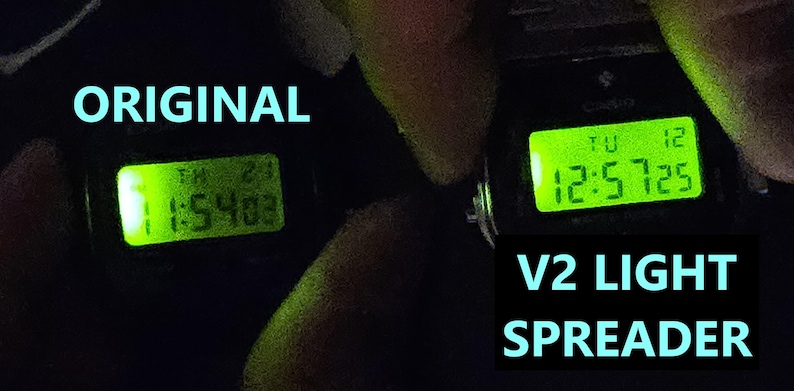 May include: Two digital watches with illuminated green displays showing the time. The left watch displays "1:54:03" and the right watch displays "12:57:25". Text in the image reads "ORIGINAL" and "V2 LIGHT SPREADER".