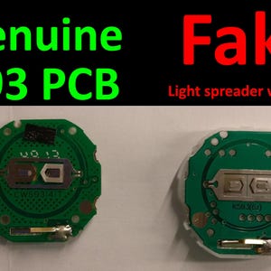 May include: Two green circuit boards, one labeled "Genuine 593 PCB" and the other "Fake." The genuine board has a small rectangular component and the text "CW593141T." The fake board has a different component layout.