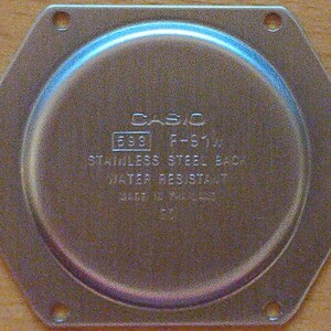 May include: A silver watch back with the text 'CASIO F-S10F 533 STAINLESS STEEL BACK WATER RESISTANT' on it.