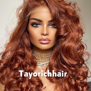 May include: A mannequin head with a copper-colored, curly wig. The wig has a lace front and is styled with voluminous waves. The mannequin is wearing a gold chain necklace. The text "Tayorichhair" is displayed at the bottom.