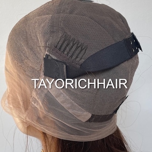 May include: A brown wig cap with adjustable straps and combs. The cap is made of a fine mesh material and has the text "TAYORICHHAIR" printed on it.