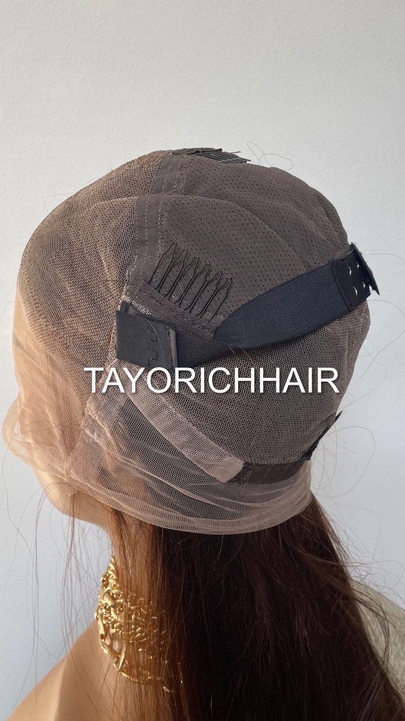 May include: A brown wig cap with adjustable straps and combs. The cap is made of a fine mesh material and has the text "TAYORICHHAIR" printed on it.