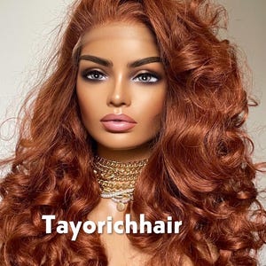 May include: A mannequin head with a copper-colored, curly wig. The wig features a lace front and voluminous curls. The mannequin wears a gold necklace. The text "Tayorichhair" is displayed at the bottom of the image.