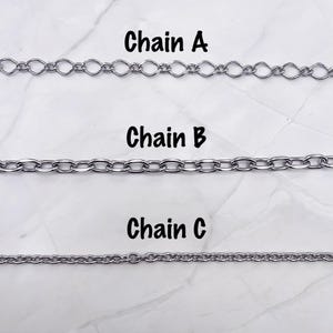 May include: Three silver-toned metal chains labeled Chain A, Chain B, and Chain C. Chain A features elongated oval links, Chain B consists of uniform oval links, and Chain C is composed of small, tightly connected circular links in a row.